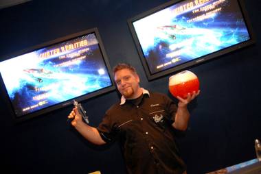 Darren Benjamen holds up a phaser and a drink during the Downstairs Bar’s Star Trek-themed party.