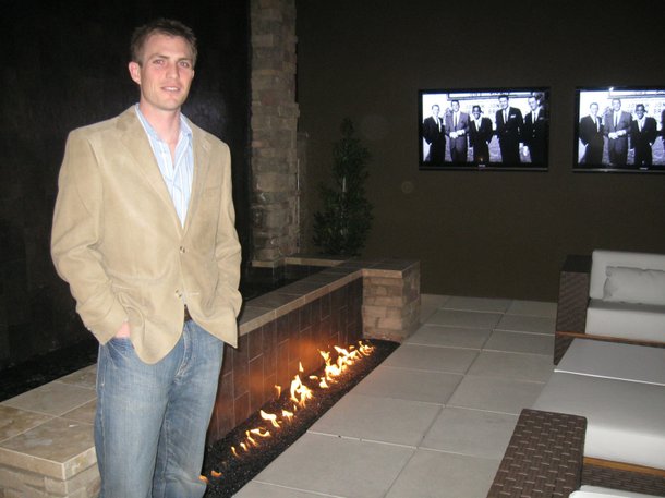 Tyler Jones, the president of Blue Heron development, stands in the courtyard (complete with waterfall, fire and flatscreens) he helped design and build.