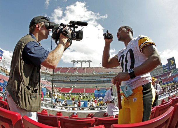 Pittsburgh Steelers' Roy Lewis films a cameraman while being interviewed during the team's media day for Super Bowl XLIII Tuesday, Jan. 27, 2009, in Tampa, Fla.