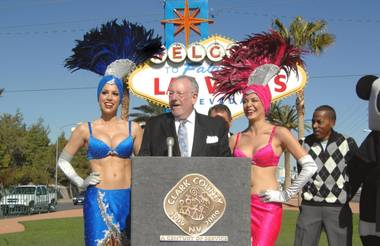 Mayor Oscar Goodman, in front of the iconic Las Vegas sign and flanked by the iconic showgirls of his city, speaks at the Earth Hour press conference on Feb. 4, 2009.