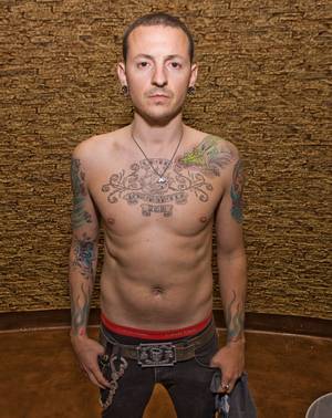 Chester Bennington goes shirtless to show off his tats.