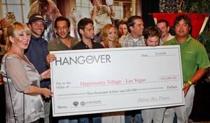 <em>The Hangover</em> cast with their check to Opportunity Village.