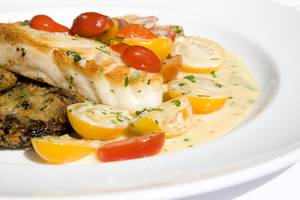 Roasted Chilean sea bass with heirloom tomatoes.