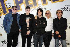 Iron Chef Kerry Simon is flanked by Cheap Trick, who will be performing at the Las Vegas Hilton in September.
