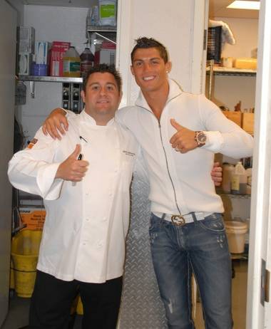 Nove Italiano executive chef Geno Bernardo and soccer superstar Cristiano Ronaldo in the kitchen of the Palms restaurant.