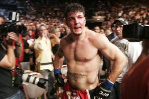 Frank Mir leaves the arena after being defeated by Brock Lesnar in their heavyweight title fight at UFC 100. Lesnar won with stoppage in the second round.