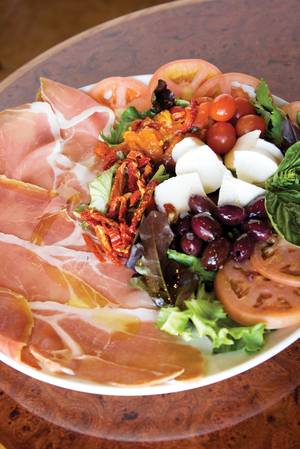 Caffe Dolce's thinly sliced San Daniele prosciutto is accompanied by burrata cheese, creamy mozzarella hearts, roasted peppers and brine-cured olives. 