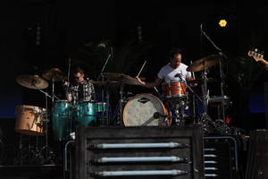 Rob Whited performing on stage with the Killers.
