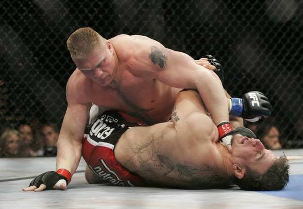 Brock Lesnar battles Frank Mir during their heavyweight title fight at UFC 100. The fight is up for Fight of the Year at the 