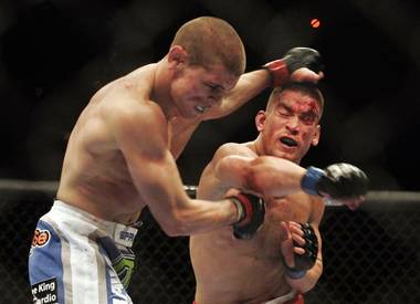 Sam Stout, right, and Joe Lauzon trade punches during their lightweight fight at UFC 108 Saturday at the MGM Grand Garden Arena. Stout won the fight by decision.