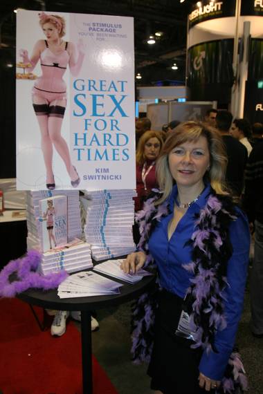 Author Kim Switnicki poses with her new book prior to a signing at the Adult Entertainment Expo.