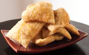 Sopapillas, a light, flaky dessert to be eaten with generous applications of butter and honey.