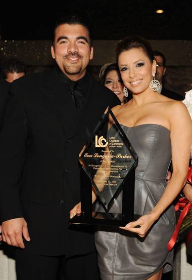 Eva Longoria Parker recieves the “Premio de Oro” award from Latin Chamber of Commerce Chairman Luis Valera on Saturday, February 20, 2010.