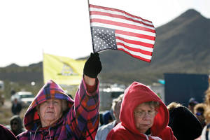 An attendee displays her sentiments by waving a U.S. flag upside down.