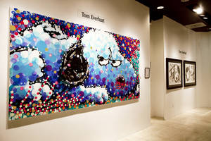 (Copyright Tom Everhart) The original museum piece "Stalking in L.A." (foreground) is on display at Jack Gallery, which exclusively produces fine art lithographs of Everhart's work. His most recent collection, <em>Scratch and Sniff</em> (background), captures the spirit of Charles Schulz and his beloved characters.   
