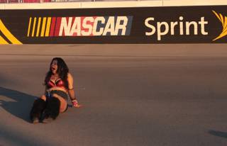 A tired EDC fan yawns while taking a rest on the LVMS track Sunday morning.