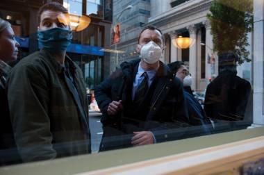Do those tiny masks really keep you from getting sick? Jude Law finds out in ‘Contagion.’