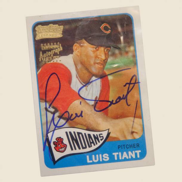 An autographed Luis Tiant baseball card, just one of the items auctioned off on Saturday.