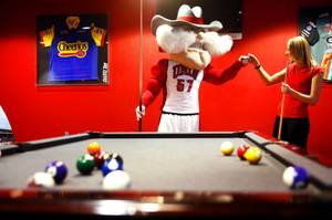 UNLV mascot Hey Reb and Weekly reporter Erin Ryan play some pool at Pole Position Raceway in Las Vegas on Tuesday, March 6, 2012.