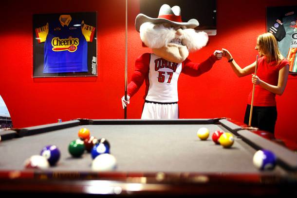 UNLV mascot Hey Reb and Weekly reporter Erin Ryan play some pool at Pole Position Raceway in Las Vegas on Tuesday, March 6, 2012.