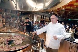 Jaleo chef Jose Andres works on browning chicken and rabbit in one of his massive paella pans during Vegas Uncork'd on May 11, 2012.