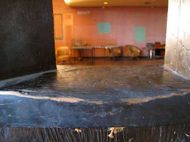 A ledge worn down from patrons leaning their elbows on it over the decades.