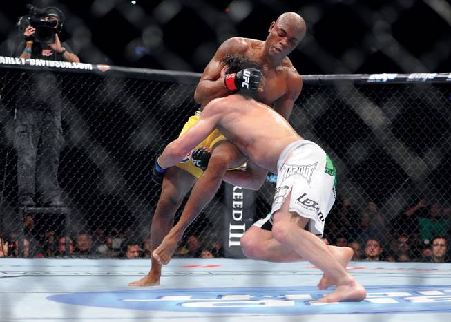 Anderson Silva, left, seen here fighting Chael Sonnen in 2012, defends his middleweight title against Chris Weidman this weekend.