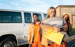 Taylor Schilling, center, portrays Piper Kerman, whose memoirs are the basis for the Netflix series <em>Orange Is the New Black</em>.