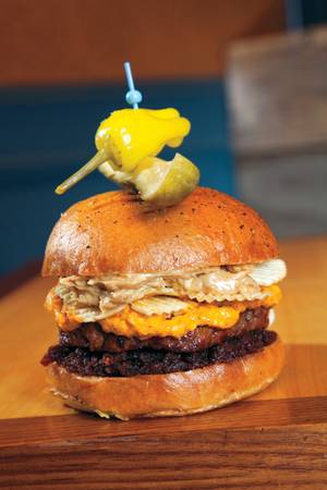 Pub 1842's Peanut Butter Crunch Burger contains peanut butter, pimento cheese, bacon jam and potato chips.