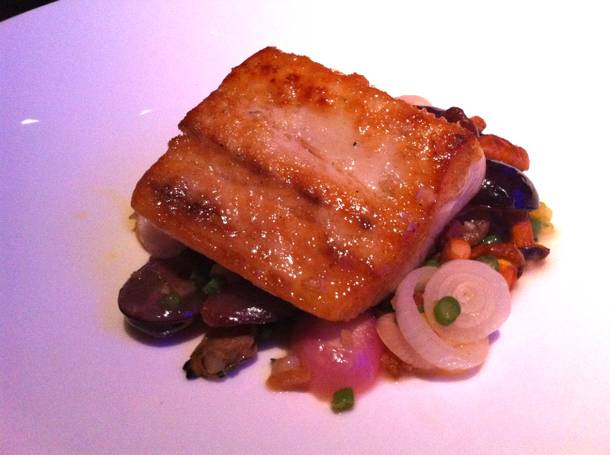 Pacific yellowtail kampachi with chanterelle mushrooms, bacon, Manila clams and black grapes.