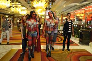 Marvick (in the background) walks with his fellow Naked Vegas employees and two of their body painting masterpiece models. The local body painting company is now being featured on Syfy's new reality program, <em>Naked Vegas</em>.