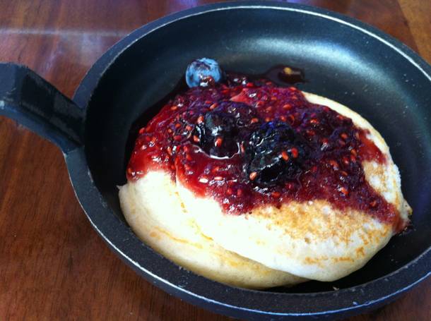 Fluffy pancakes with warm berry compote are a simple highlight at La Cave's Sunday brunch.