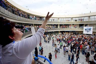 Not-so-humble beginning: Zappos employee Ana Santiago catches confetti during the grand opening of Zappos’ Downtown location in 2013.
