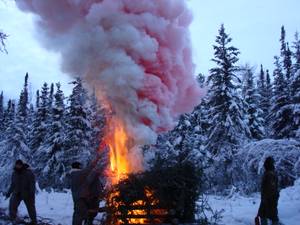 S.E.R.E. guys build a "smoke generator" signal fire during arctic survival training near Fairbanks, Alaska. A smoke generator this size can generate a column of smoke several hundred feet high that lasts up to 20 minutes.