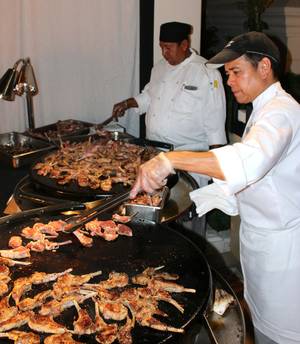 Chefs from Samba Brazilian Steakhouse grill lamb chops at UNLVino's Bar-B-Q event.