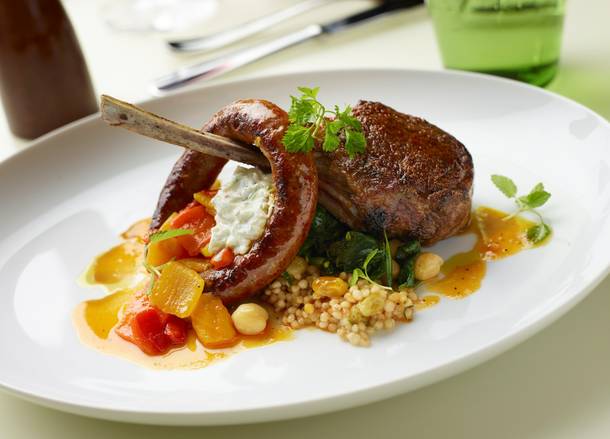 DB Brasserie's duo of lamb includes a Tunisian-spiced sausage and an Australian lamb chop with couscous, lemon-braised spinach and minted yogurt. 