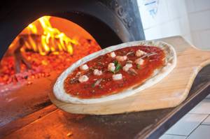 The Napoletana pizza, with anchovies, shrimp, capers, garlic and oregano, hits the oven at 800 Degrees.