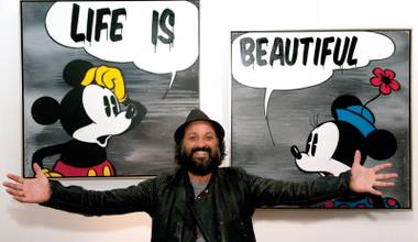 Life imitates art? Mr. Brainwash, aka Thierry Guetta, poses in front of his work at an exhibition in London in 2011.