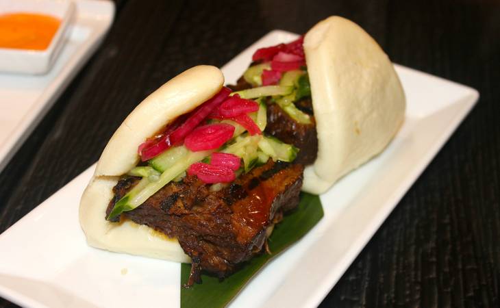 Grilled beef short rib bao bun in ginger-sake reduction with cucumber and pickled red onion.