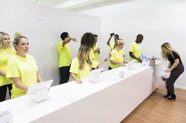 Employees await customers at the purchase counter at the Kanye West Pablo pop-up shop at Fashion Show Mall, Friday, Aug. 2016.