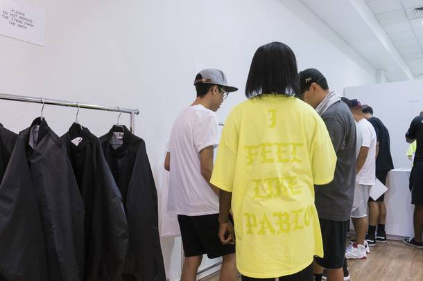 An employee helps customers with their purchase at the Kanye West Pablo pop-up shop at Fashion Show Mall, Friday, Aug. 2016.