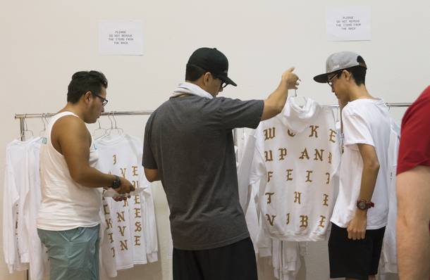 Customers browse the merchandise at the Kanye West Pablo pop-up shop at Fashion Show Mall, Friday, Aug. 2016.