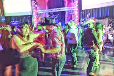 Patrons dance to live music by Banda Destructora at Club Tequila, a latin-themed nightclub, located inside Fiesta Rancho Hotel and Casino, Saturday, Aug. 13, 2016.