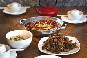 Toothpick lamb with cumin, fish with tofu pudding in hot sauce and wonton in red chili at Chengdu Taste. <em>(Steve Marcus/Staff)</em>