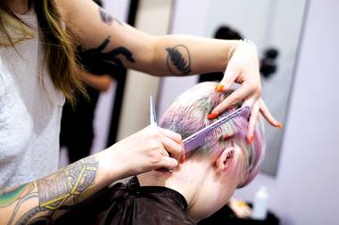 Alex McDonald cuts a customer’s hair.