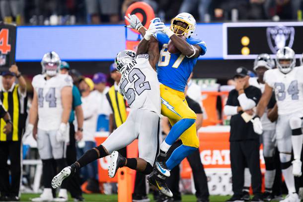 Chargers tight end Jared Cook (87) catches a pass over Raiders linebacker Denzel Perryman during the teams’ Monday Night Football game in LA on October 4.