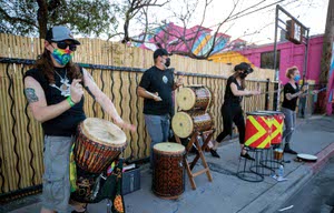 Drummers perform in the Arts District during First Friday on April 2, 2021.