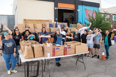 Mindy Poortinga, center, distributing food boxes with staff and volunteers at the United Movement Organized Kindness warehouse