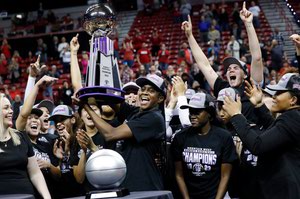 Desi-Rae Young, center, celebrates with the team after UNLV defeated Wyoming, 71-60, to win the Mountain West tournament championship at the Thomas & Mack Center on March 8.