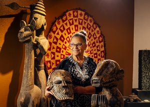 Vicki Richardson, founder and president of the Left of Center Gallery, holds a Bongo Mask from the Kuba People of the Congo.